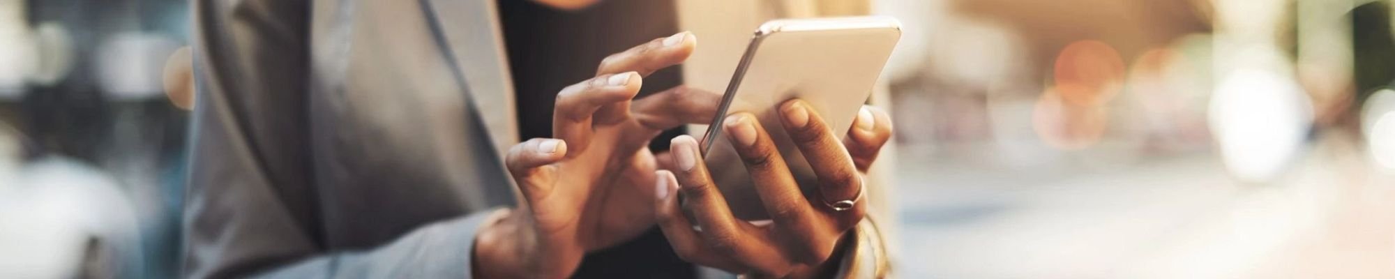 women navigate on smartphone from Potomac Tile and Carpet in Frederick, MD