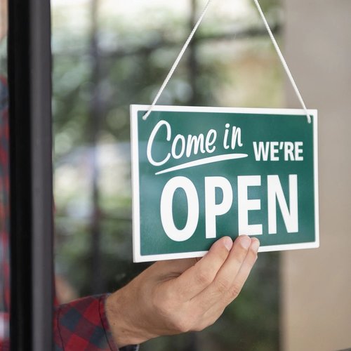 open sign in store window at Potomac Tile and Carpet in Frederick, MD